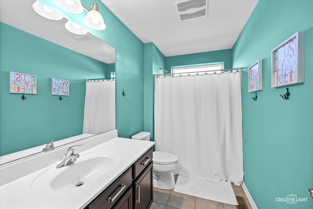 bathroom with vanity, a shower with curtain, toilet, and tile patterned flooring