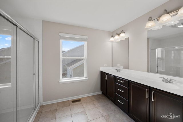 bathroom featuring vanity, tile patterned flooring, and walk in shower