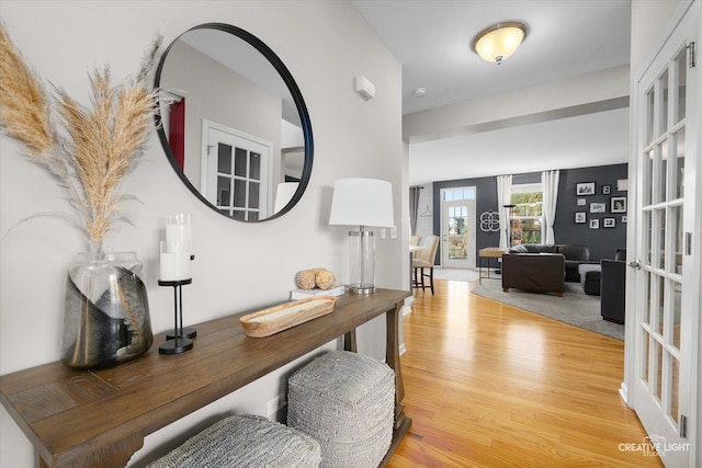 hallway featuring light hardwood / wood-style floors and french doors