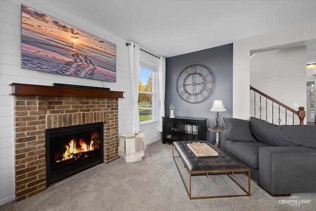 carpeted living room with wood walls and a brick fireplace