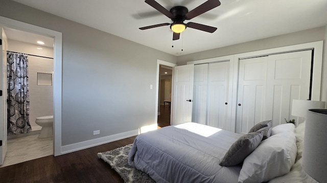 bedroom with dark wood-type flooring, ceiling fan, connected bathroom, and multiple closets