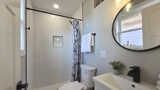 bathroom with toilet, plenty of natural light, and a shower with shower curtain