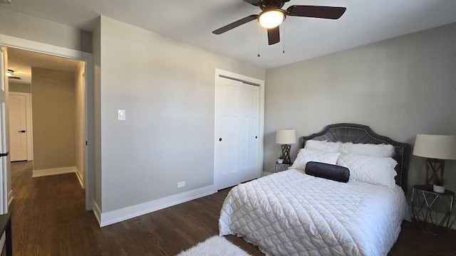 bedroom featuring ceiling fan, dark wood-type flooring, and a closet