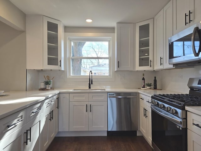 kitchen featuring white cabinets, appliances with stainless steel finishes, and sink