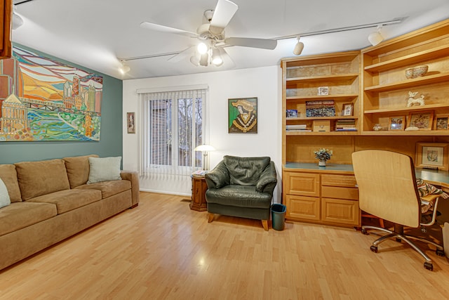 office area featuring ceiling fan, rail lighting, and light hardwood / wood-style flooring