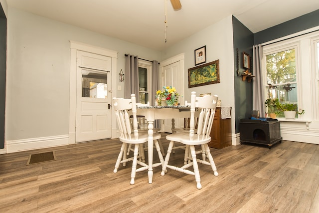 dining room with light hardwood / wood-style floors and ceiling fan