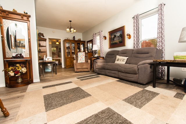 living room with light hardwood / wood-style flooring and a notable chandelier