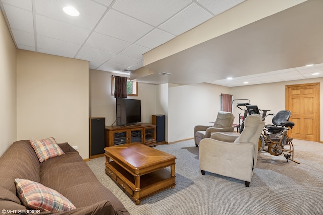 carpeted living room with a paneled ceiling