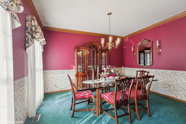 carpeted dining space with ornamental molding and an inviting chandelier