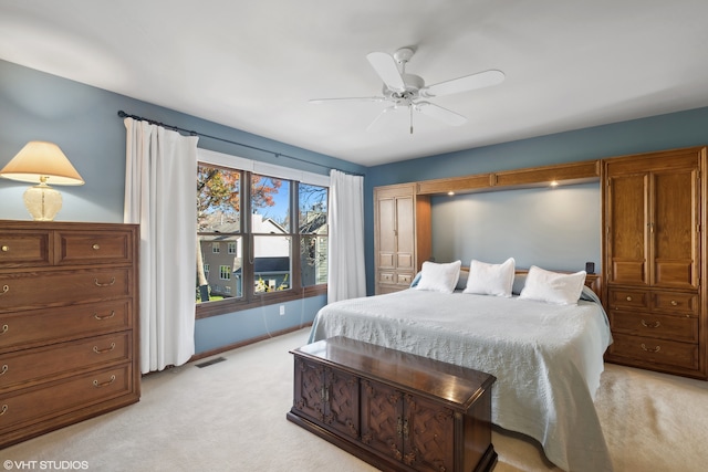 bedroom featuring light colored carpet and ceiling fan