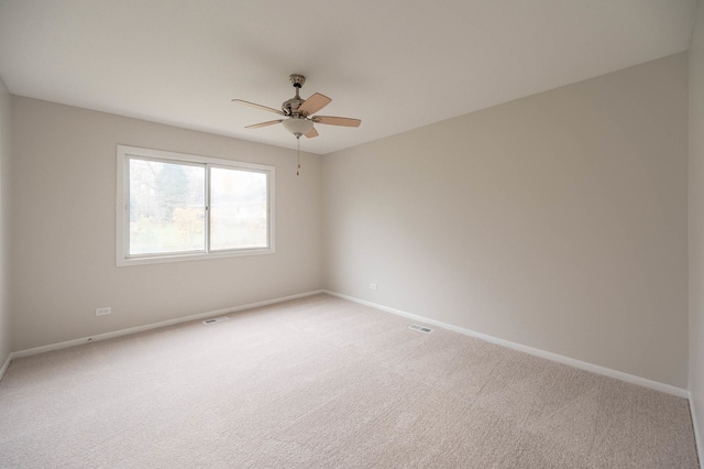 spare room with carpet flooring and ceiling fan