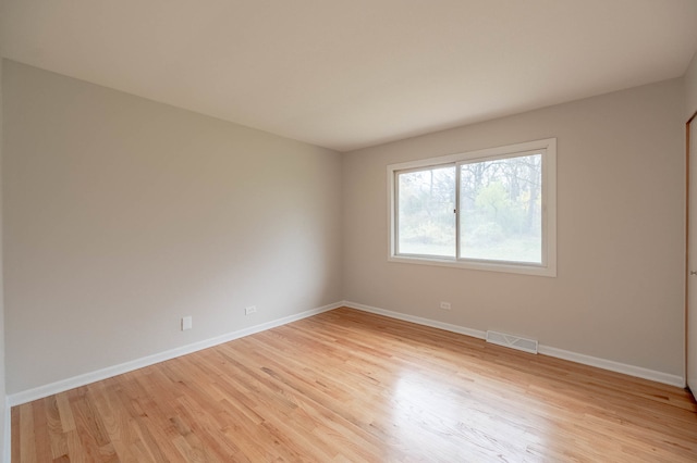 unfurnished room with light wood-type flooring