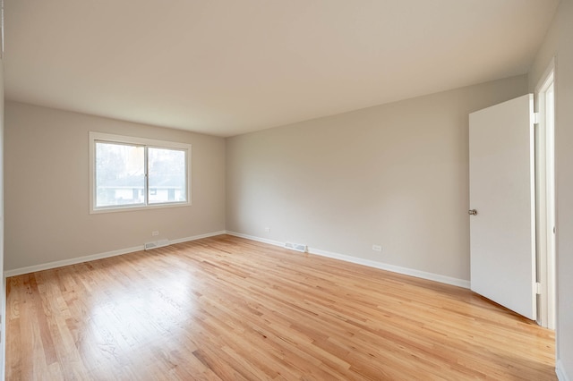 spare room featuring light hardwood / wood-style flooring