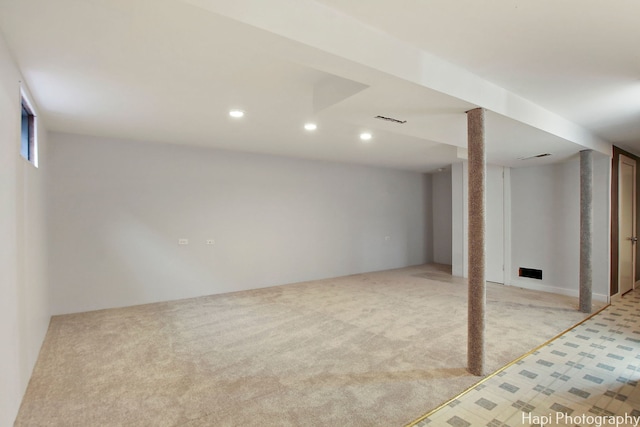 basement featuring light carpet