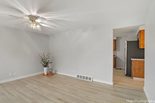 unfurnished room featuring ceiling fan and light hardwood / wood-style flooring