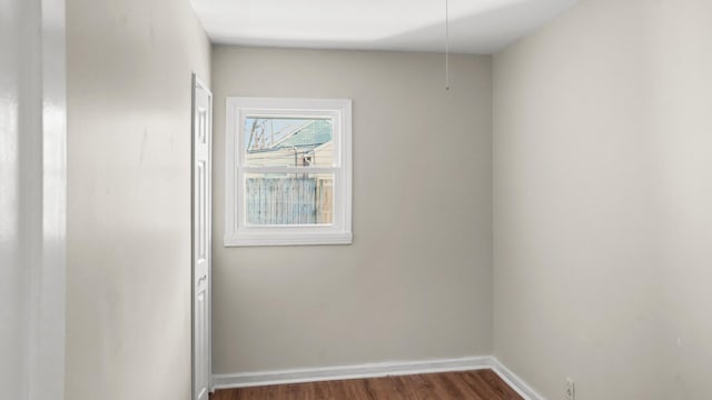 spare room with dark hardwood / wood-style floors