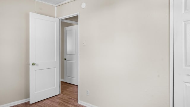 interior space featuring light hardwood / wood-style floors and crown molding