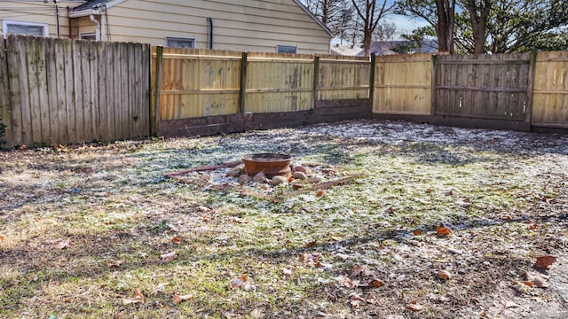 view of yard with a fire pit