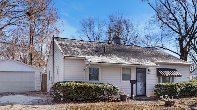 view of front facade with a garage and an outdoor structure