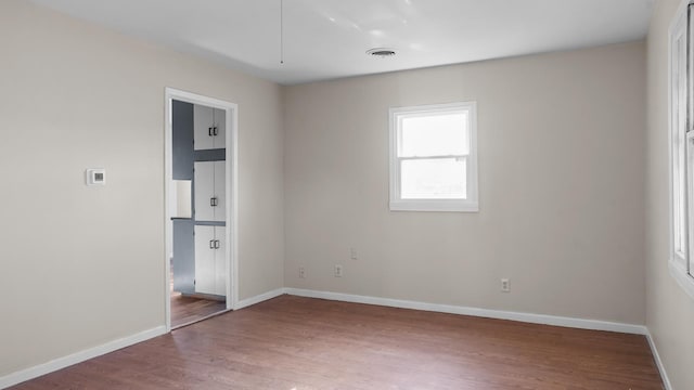 spare room with wood-type flooring