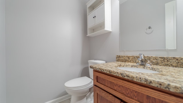 bathroom featuring toilet and vanity