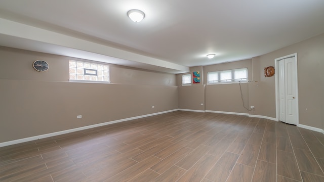 basement with dark hardwood / wood-style flooring