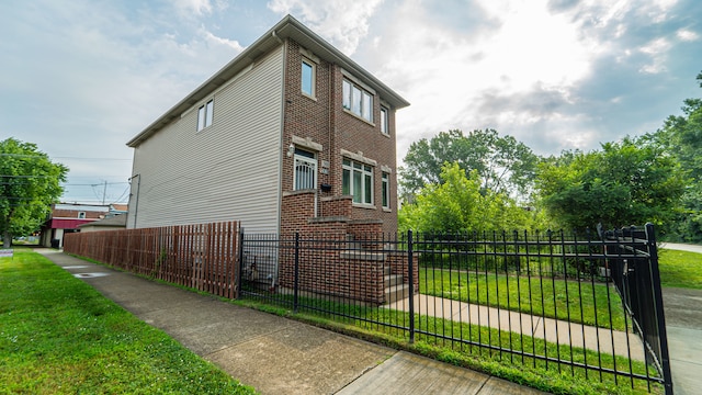 view of side of home with a yard