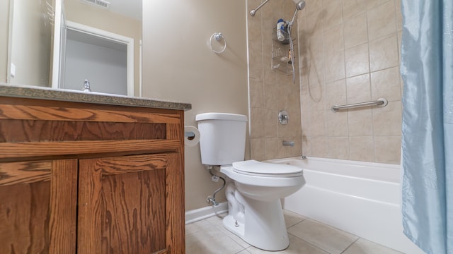 full bathroom featuring vanity, tile patterned floors, shower / bath combo with shower curtain, and toilet