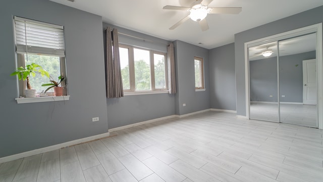 empty room featuring light wood-type flooring and ceiling fan