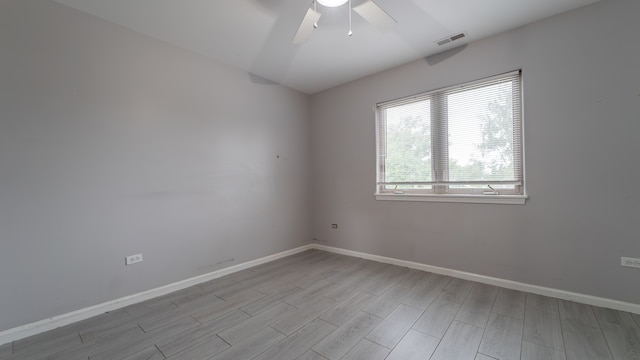 spare room with light hardwood / wood-style floors and ceiling fan