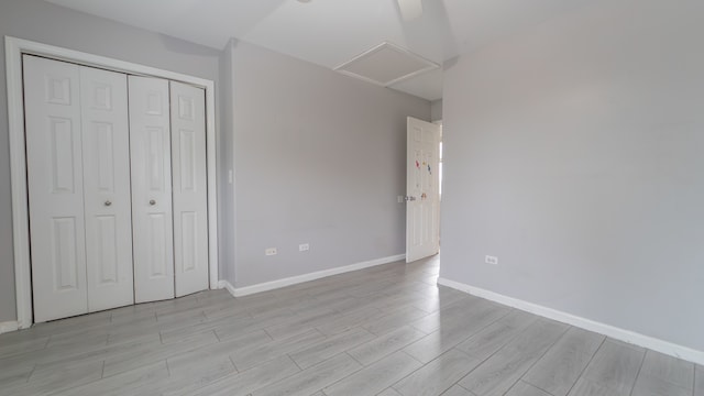 unfurnished bedroom with a closet and light hardwood / wood-style floors