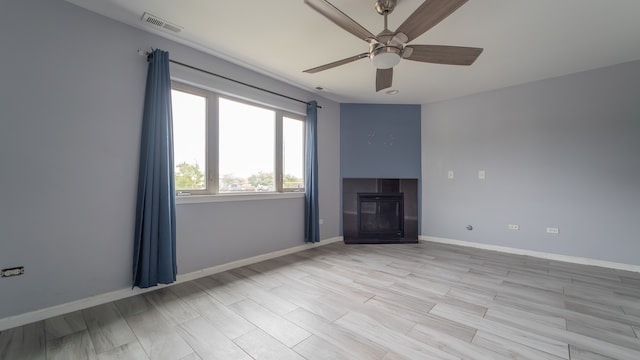 unfurnished living room with ceiling fan and light hardwood / wood-style floors