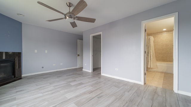 unfurnished living room featuring light wood-type flooring and ceiling fan