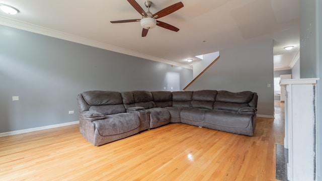 living room with ceiling fan, wood-type flooring, and ornamental molding