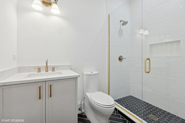 bathroom with a shower with door, vanity, and toilet