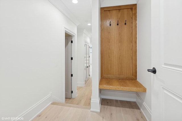 mudroom with light hardwood / wood-style flooring and ornamental molding