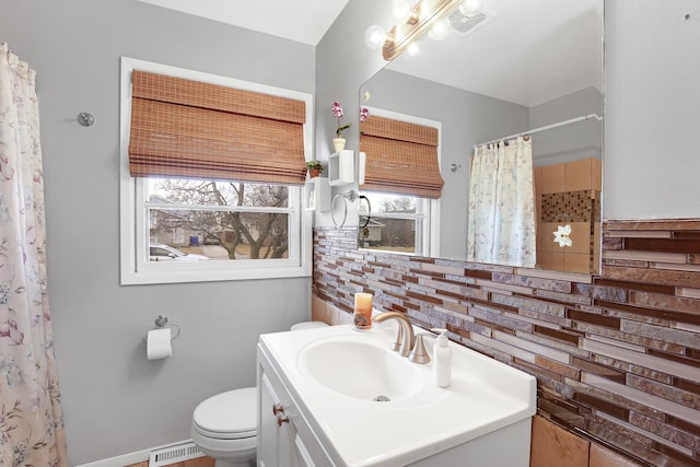 bathroom featuring vanity, curtained shower, and toilet