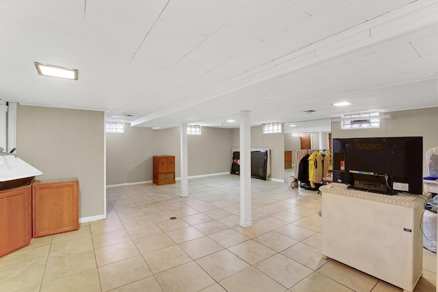 basement featuring light tile patterned flooring and a wealth of natural light