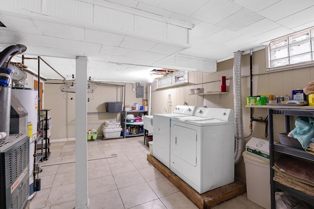 laundry room with light tile patterned flooring and washing machine and clothes dryer