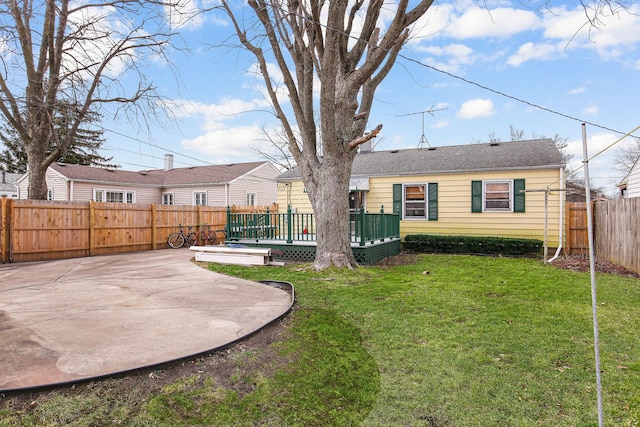 back of house featuring a wooden deck, a yard, and a patio area