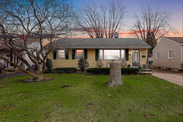 ranch-style home with a lawn