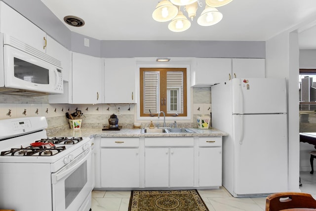 kitchen with white cabinetry, white appliances, sink, and tasteful backsplash