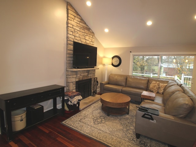 living room featuring a stone fireplace, dark wood-type flooring, and lofted ceiling