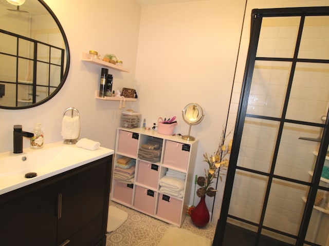 bathroom with vanity and tiled shower