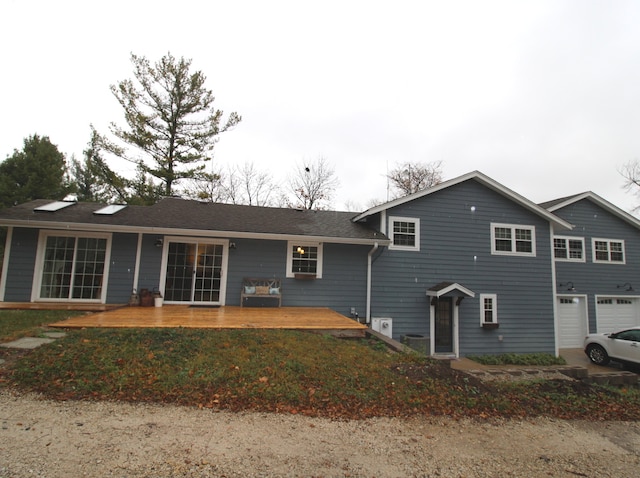 rear view of house featuring a garage and a patio