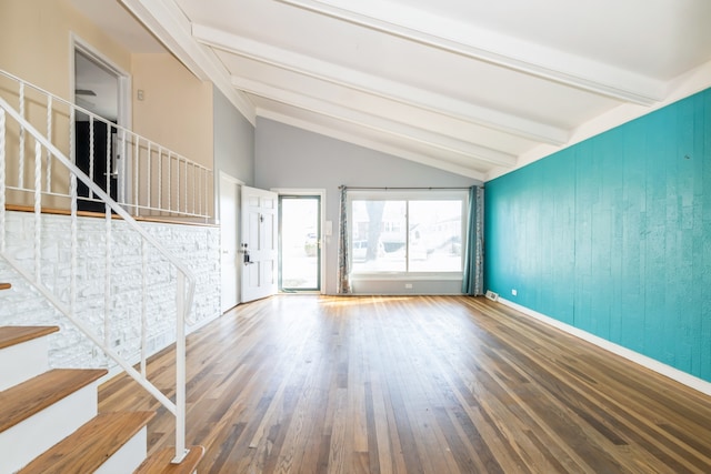 unfurnished living room featuring lofted ceiling with beams and wood-type flooring