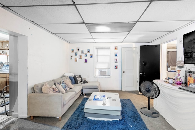 living room featuring a paneled ceiling and dark carpet