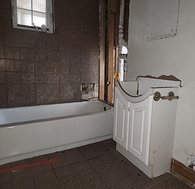 bathroom with a bath and vanity