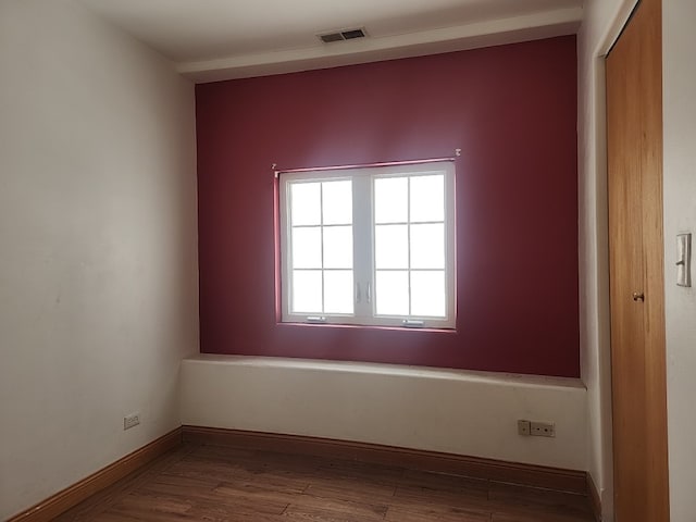 unfurnished room with wood-type flooring