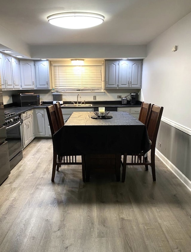 dining room featuring sink and wood-type flooring